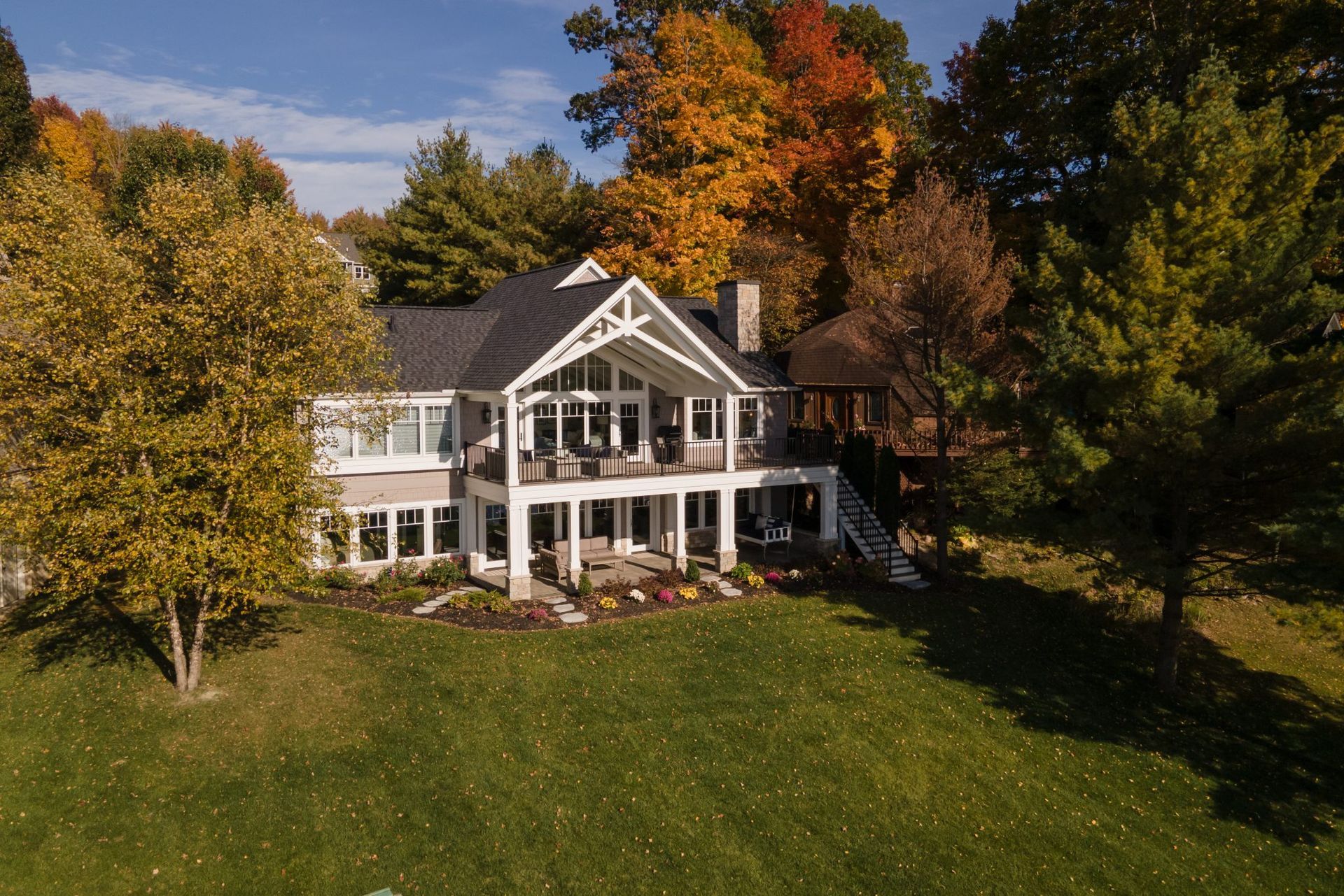 An aerial view of a large house surrounded by trees.