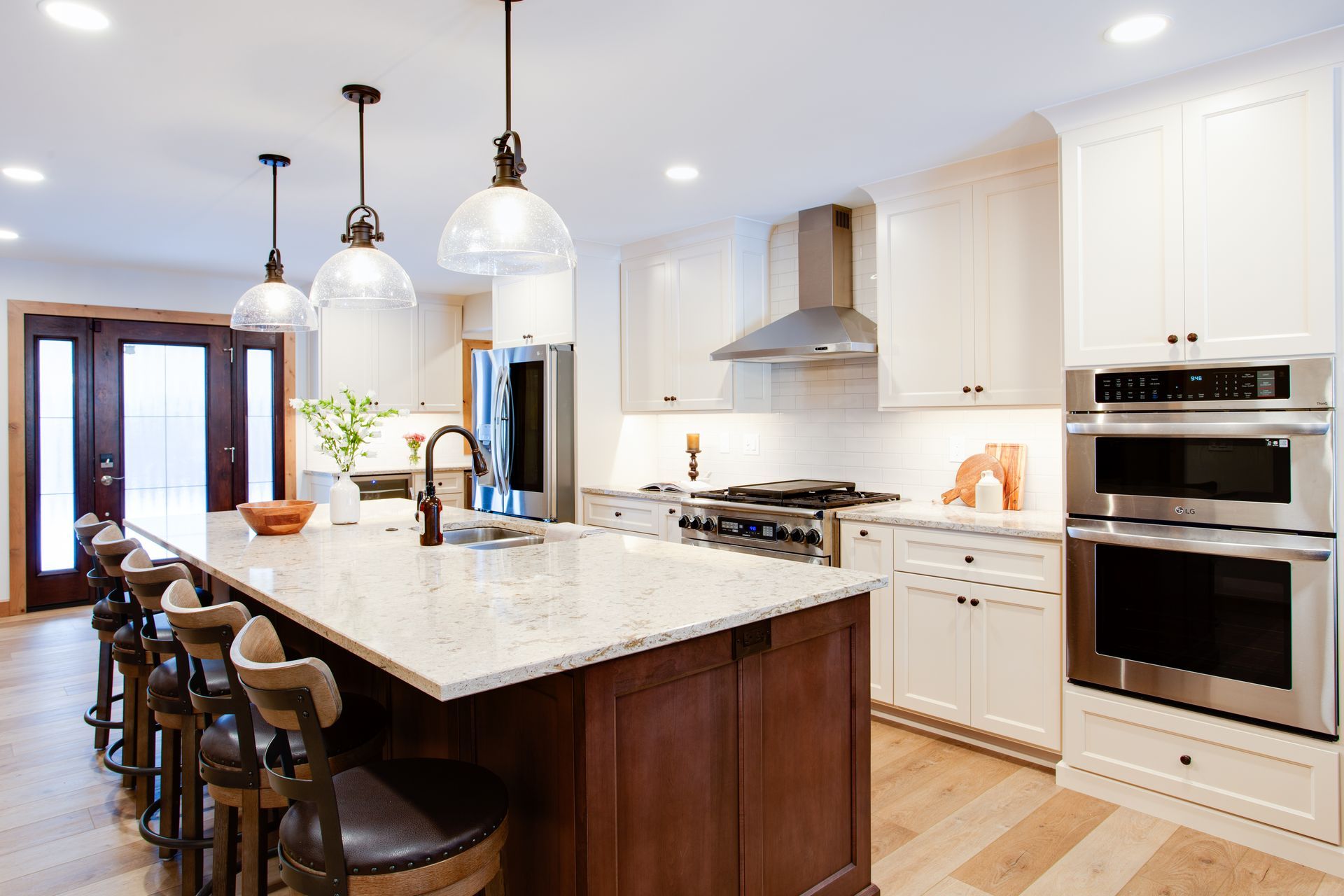 A kitchen with white cabinets and stainless steel appliances.