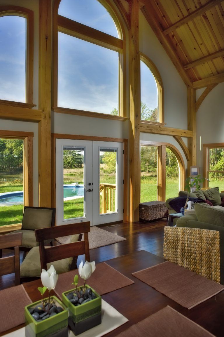 A living room with a table and chairs and a large window