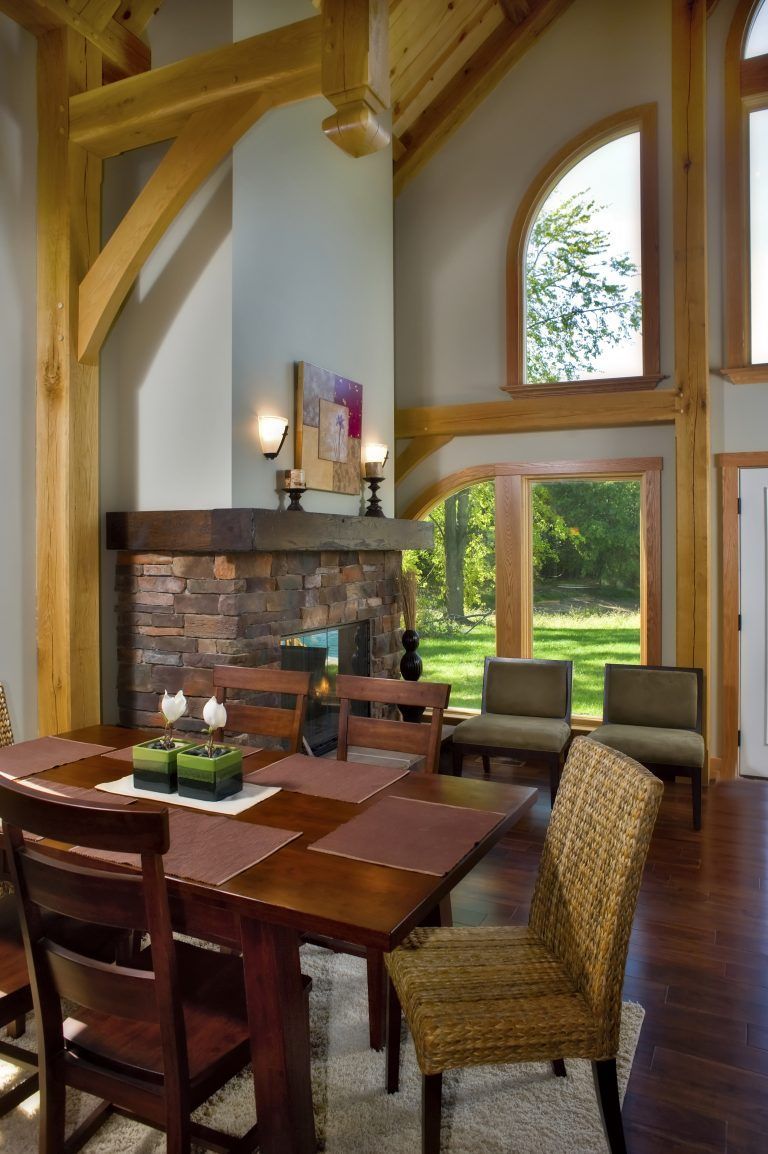 A dining room with a table and chairs and a fireplace