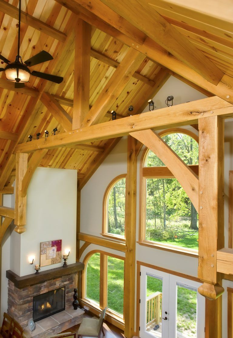 A living room with a fireplace and a ceiling fan.