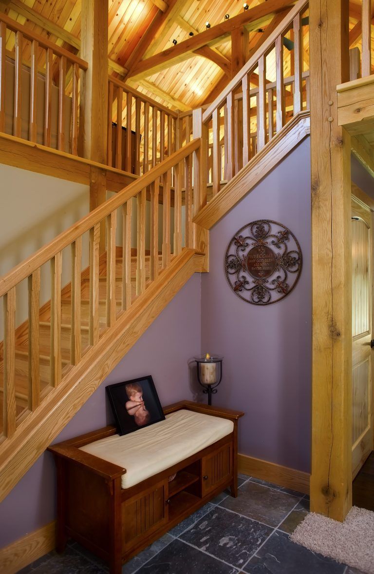 A wooden staircase with a bench underneath it.