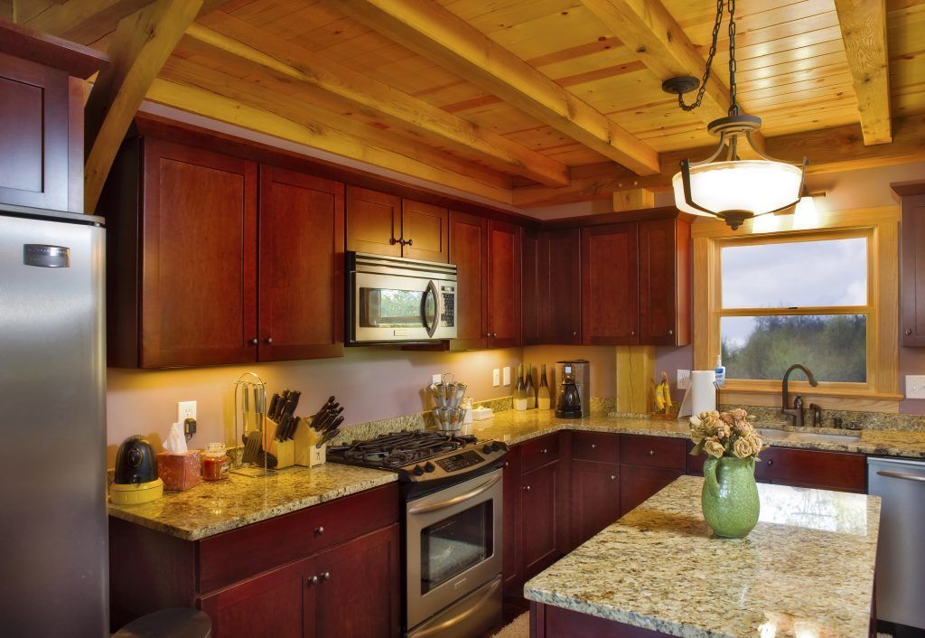 A kitchen with stainless steel appliances and granite counter tops.