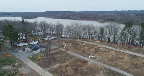 An aerial view of a residential area next to a lake.