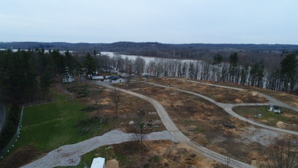 An aerial view of a residential area with a lake in the background.