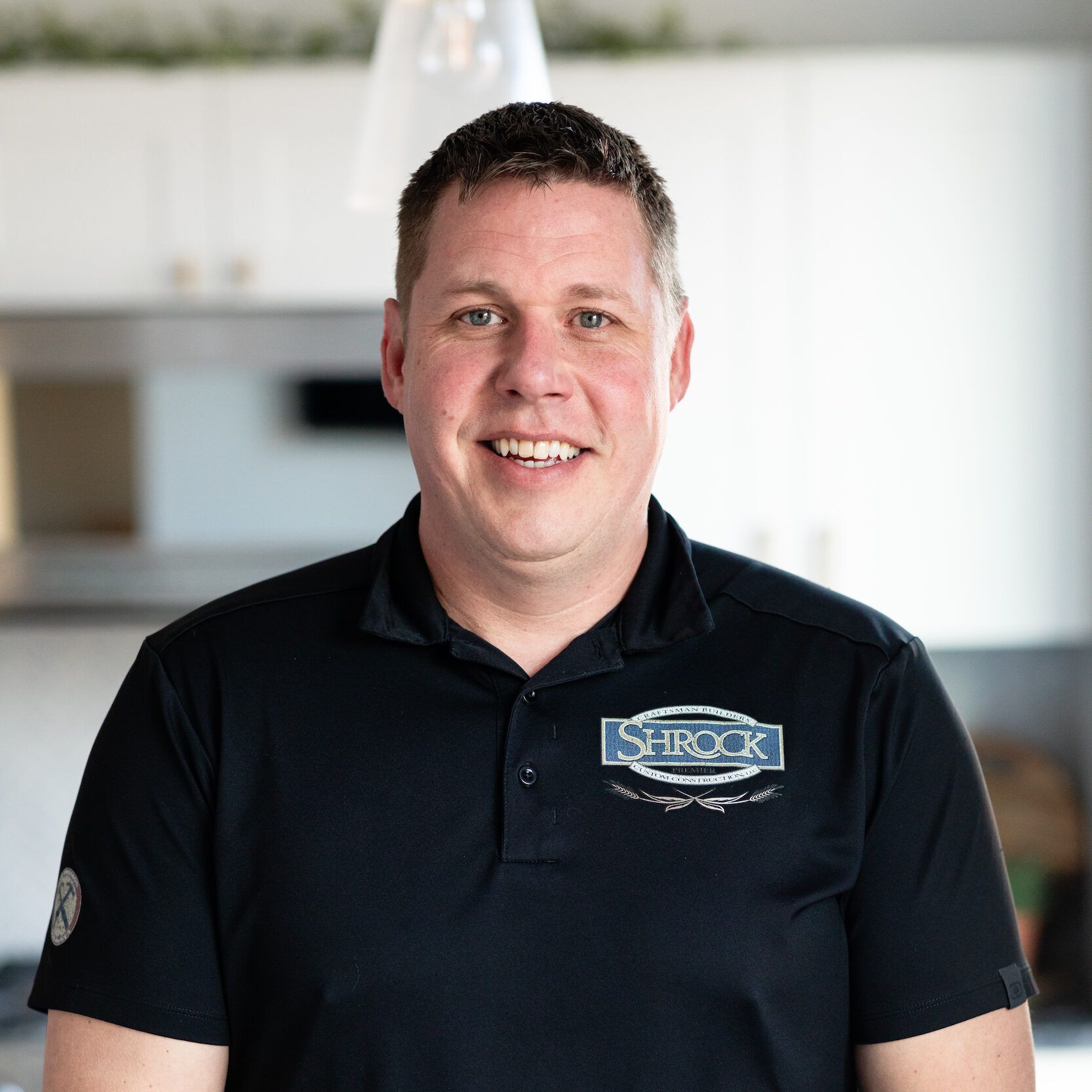 A man wearing a black shirt with the word struck on it