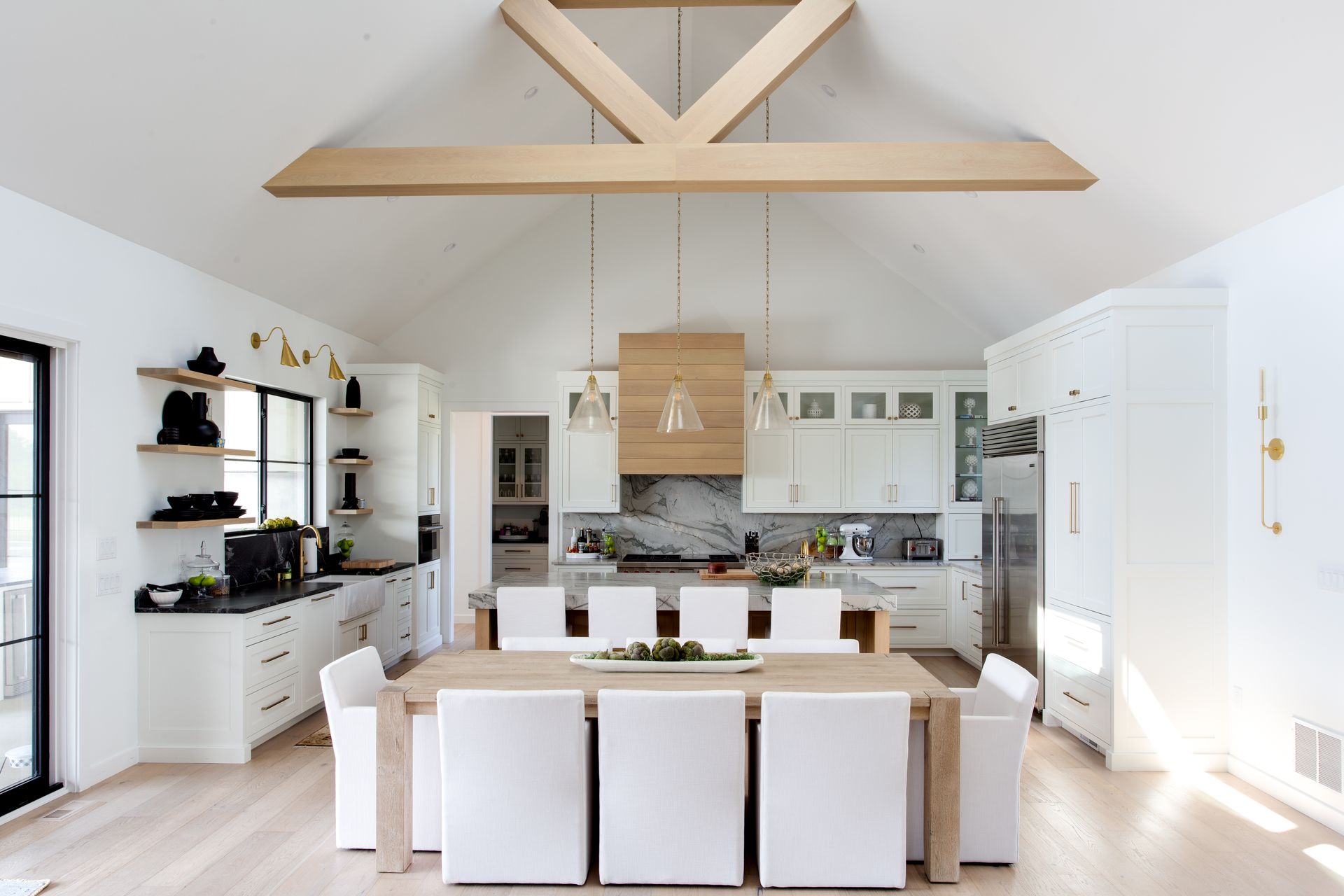 A kitchen with a dining table and chairs in it.