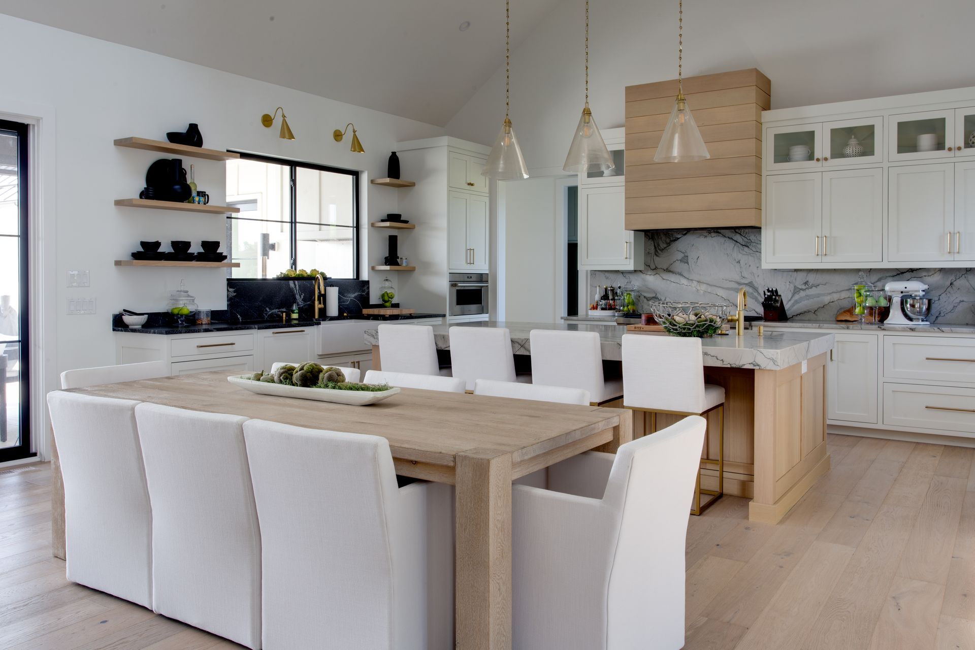A kitchen with a table and chairs in it.