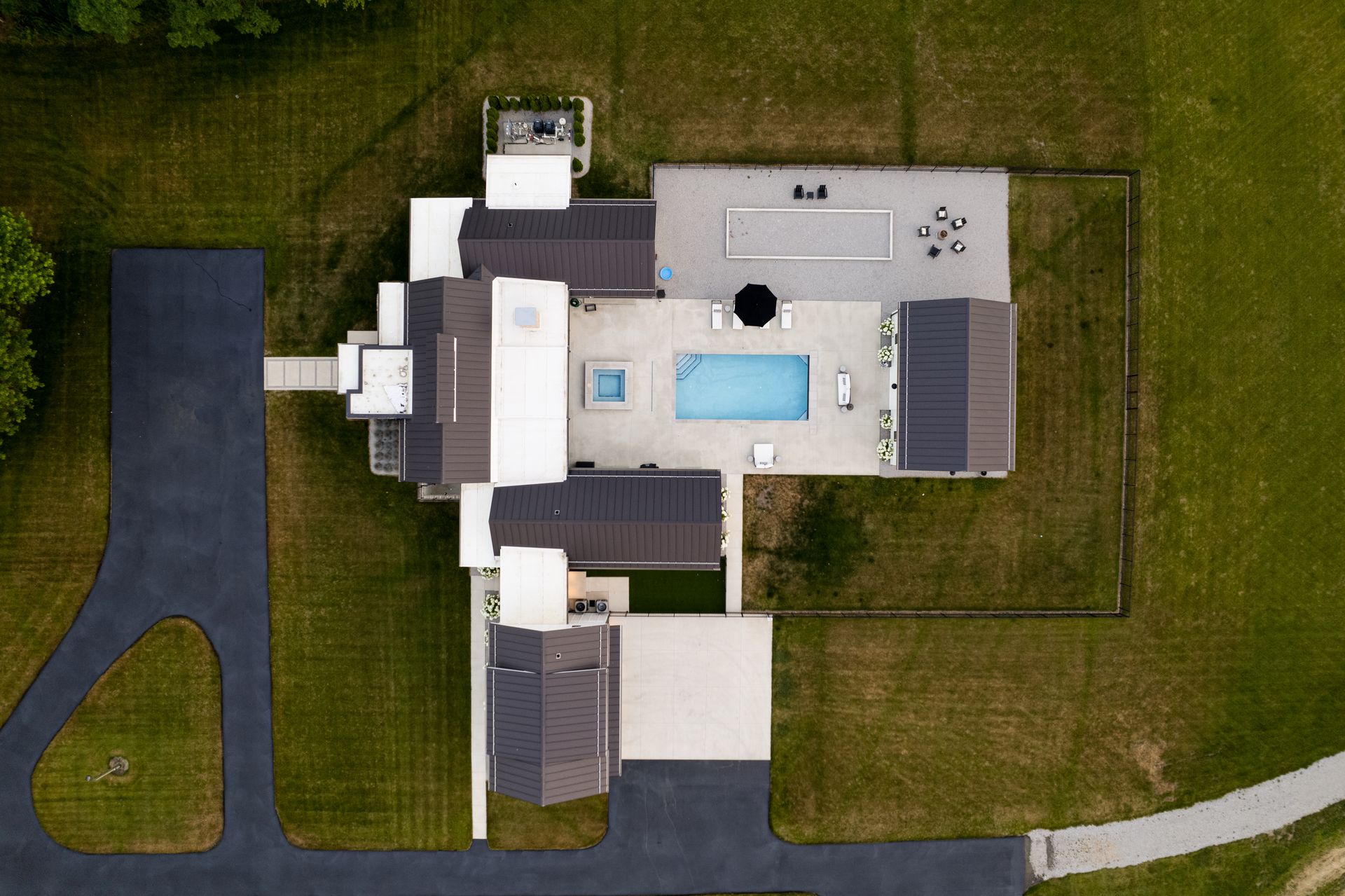 An aerial view of a house with a pool in the backyard.