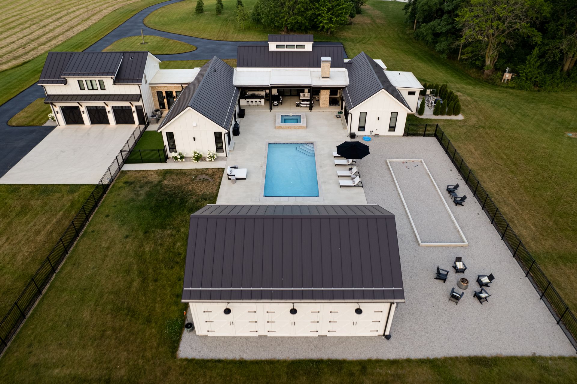 An aerial view of a large house with a swimming pool.