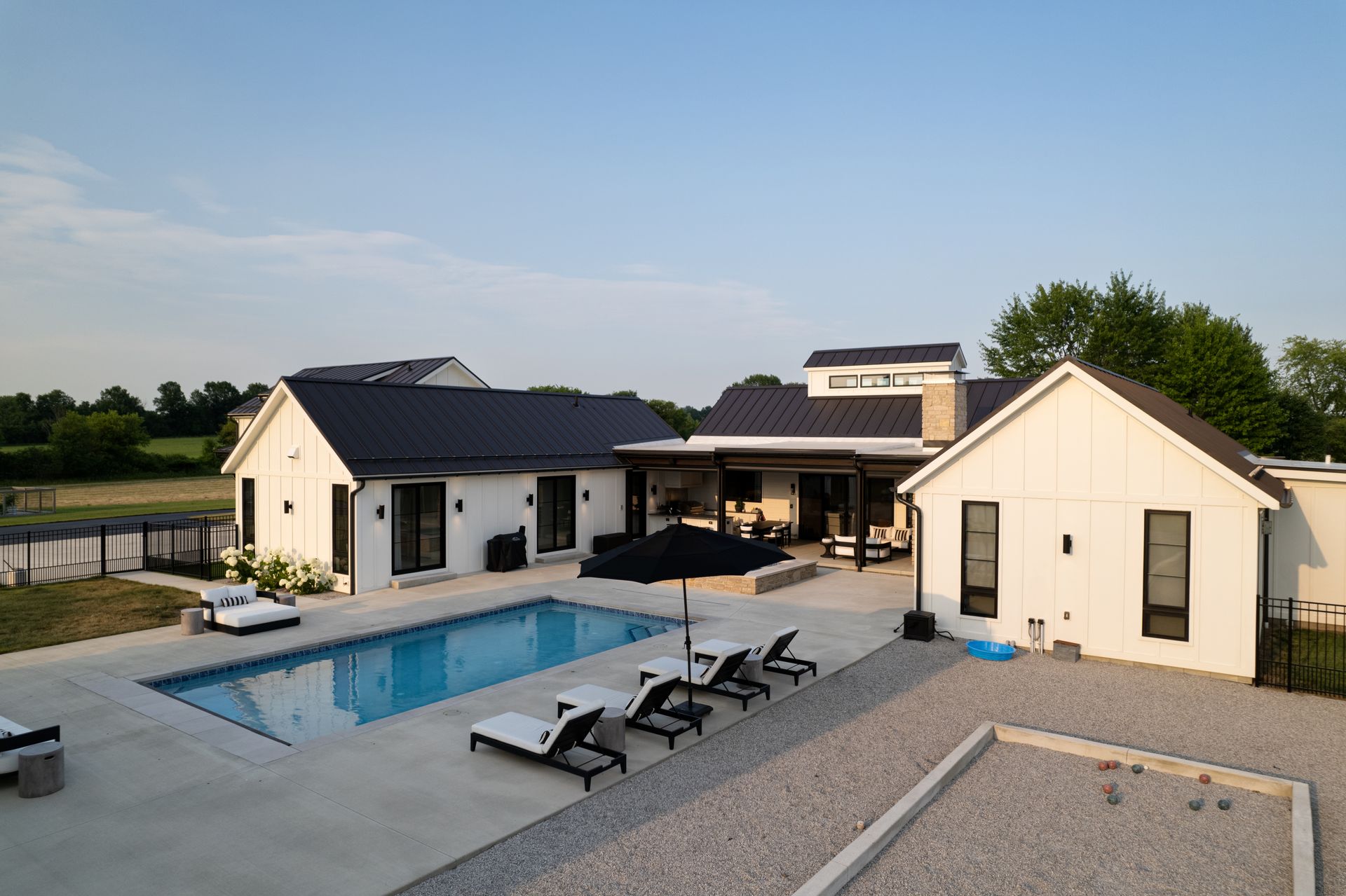 A large white house with a large swimming pool in the backyard.