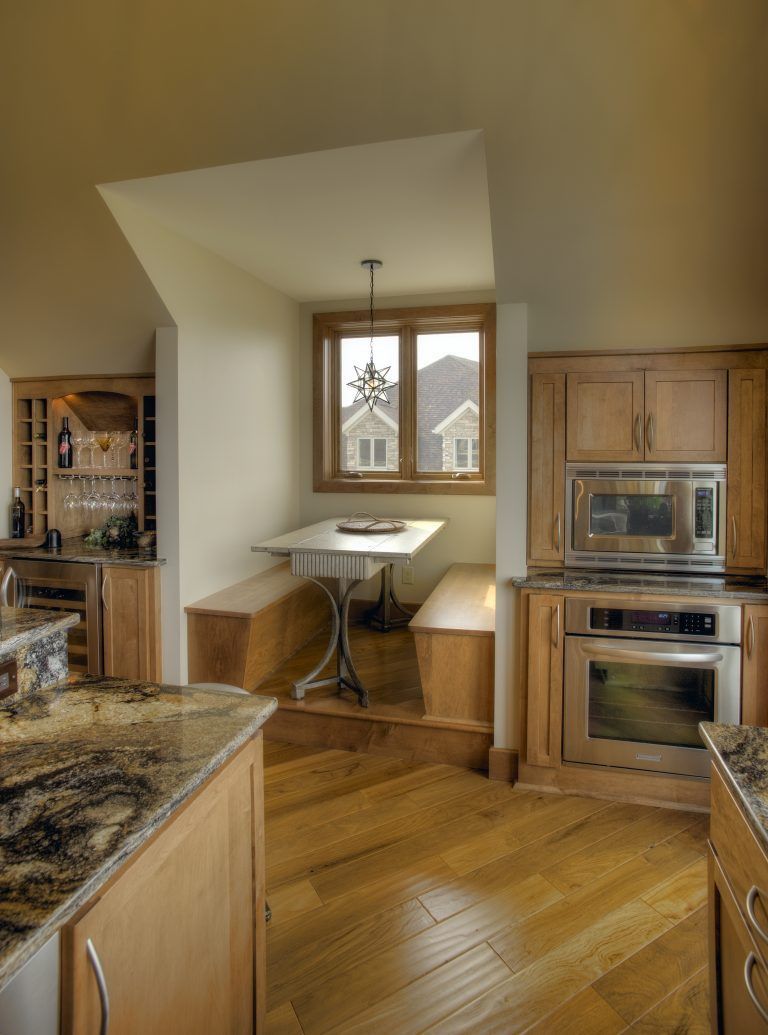 A kitchen with stainless steel appliances and wooden cabinets.