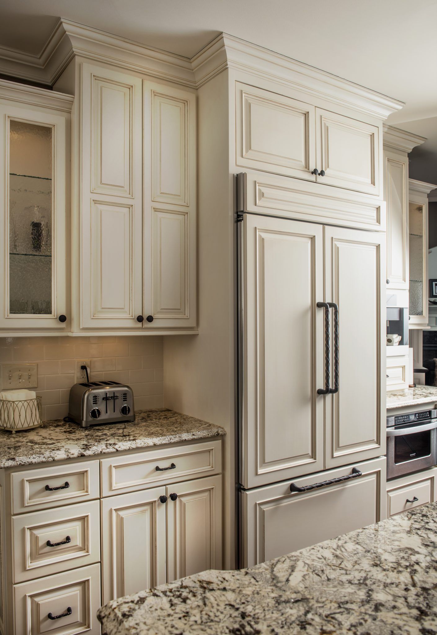A kitchen with white cabinets and granite counter tops