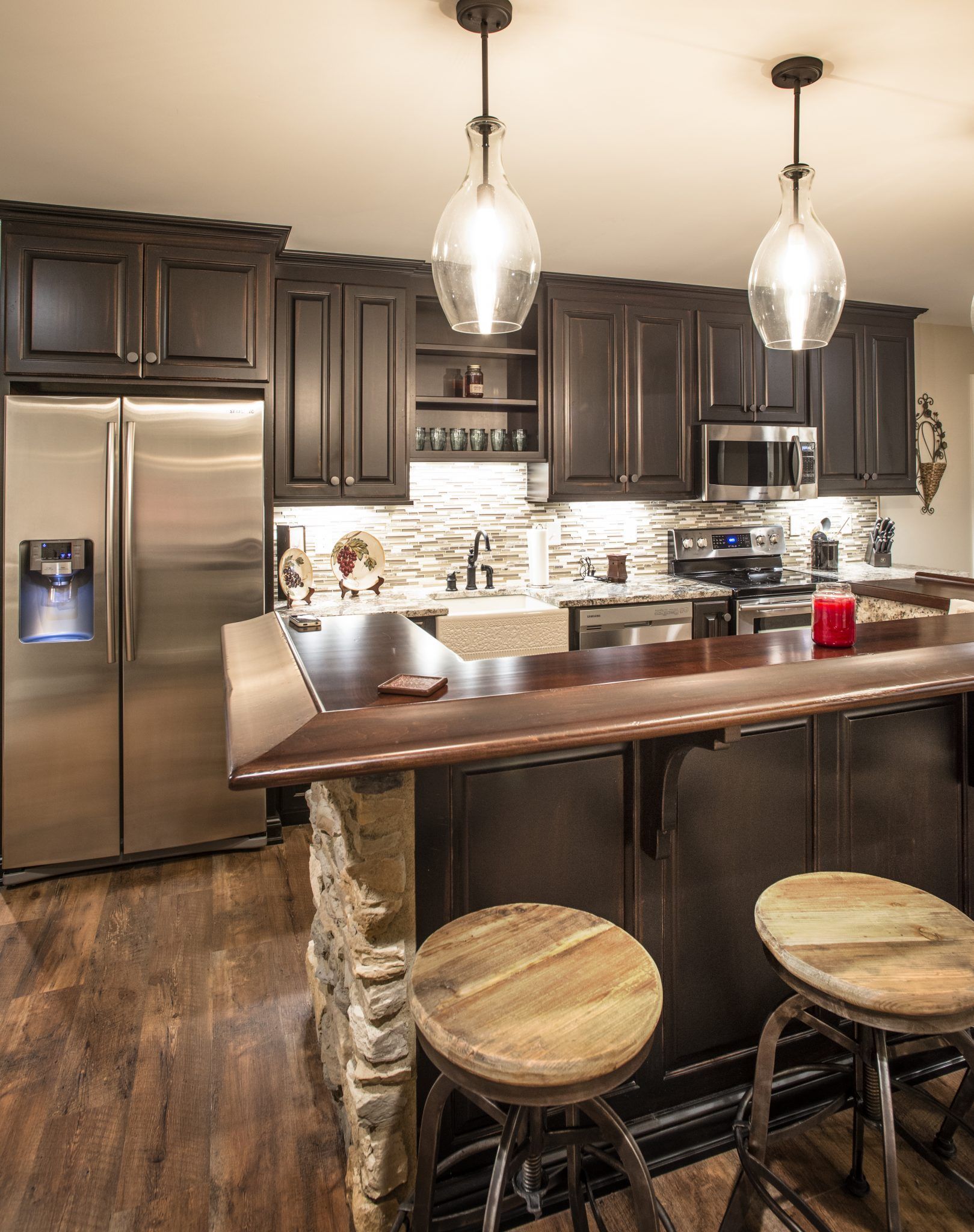 A kitchen with stainless steel appliances and wooden cabinets.