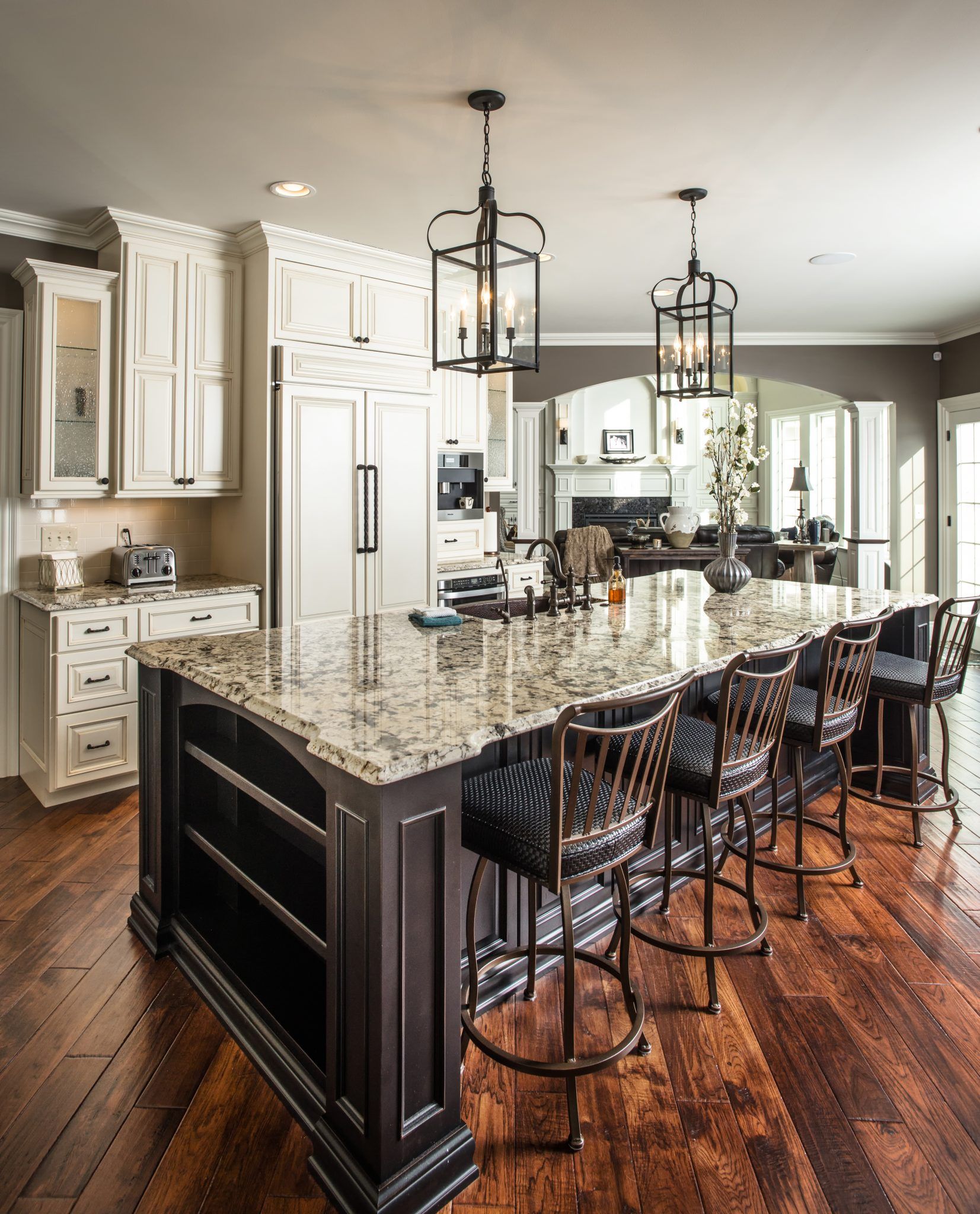 A kitchen with a large island and stools
