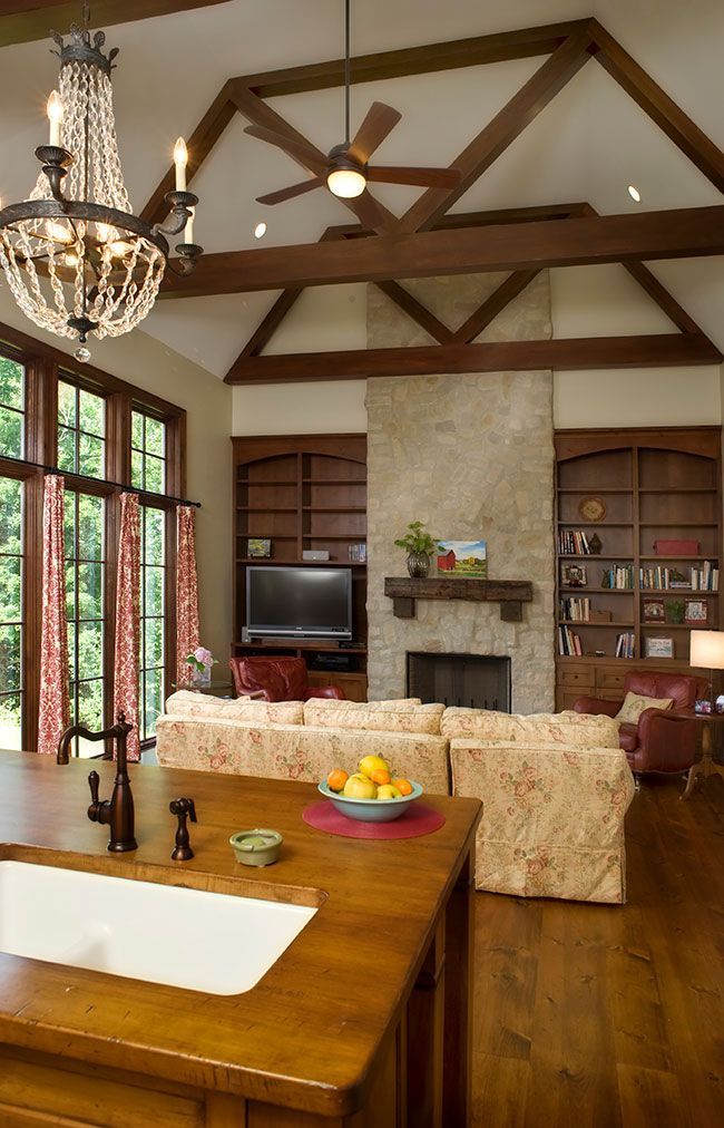 A living room with a fireplace and a sink.