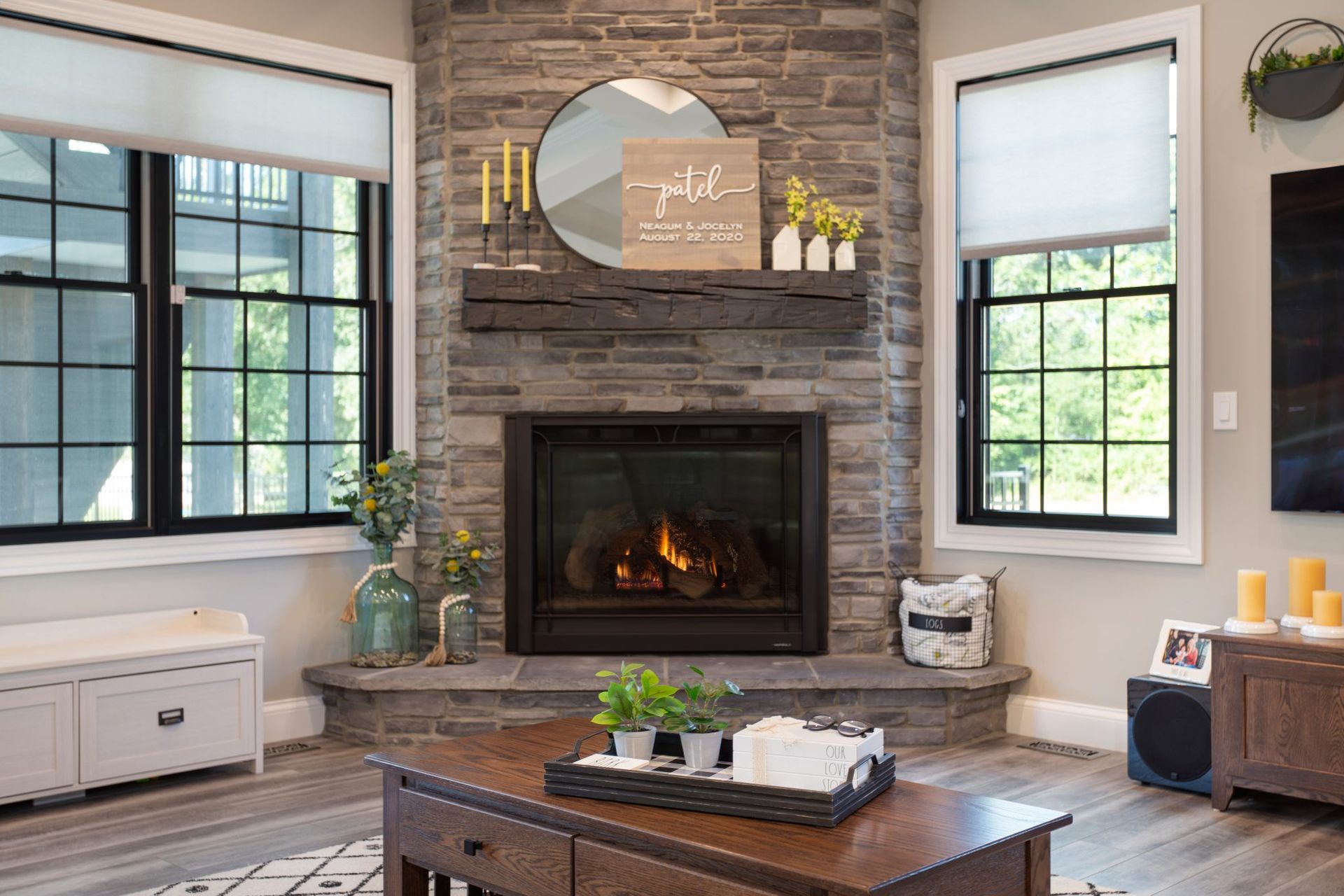 A living room with a fireplace , coffee table , and television.