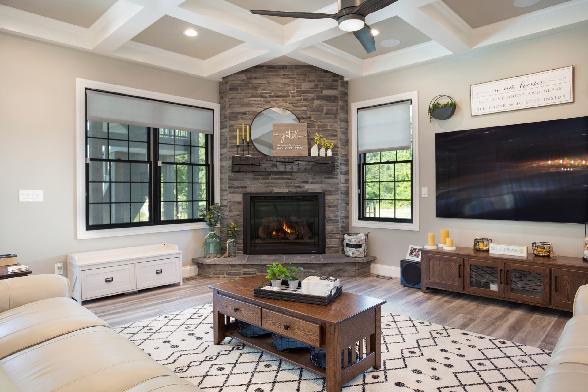 A living room with a fireplace and a flat screen tv.