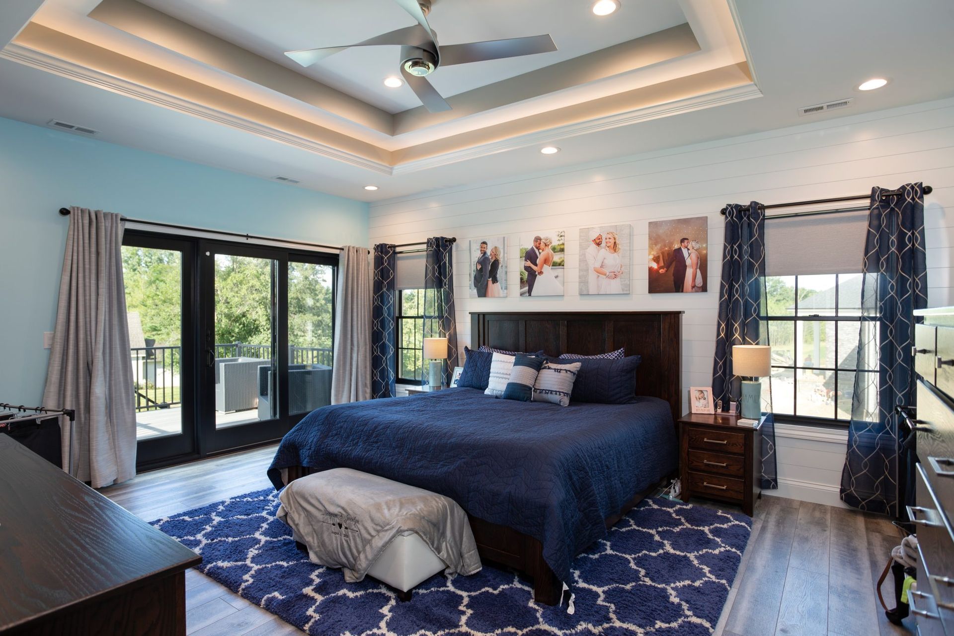 A bedroom with a large bed and a ceiling fan