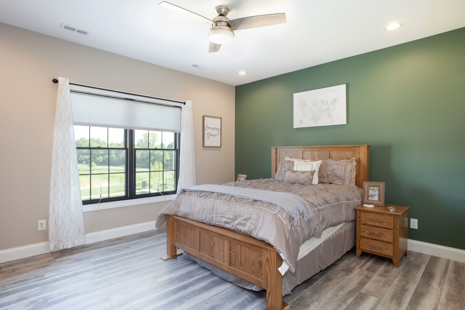 A bedroom with a bed , nightstand , window and ceiling fan.