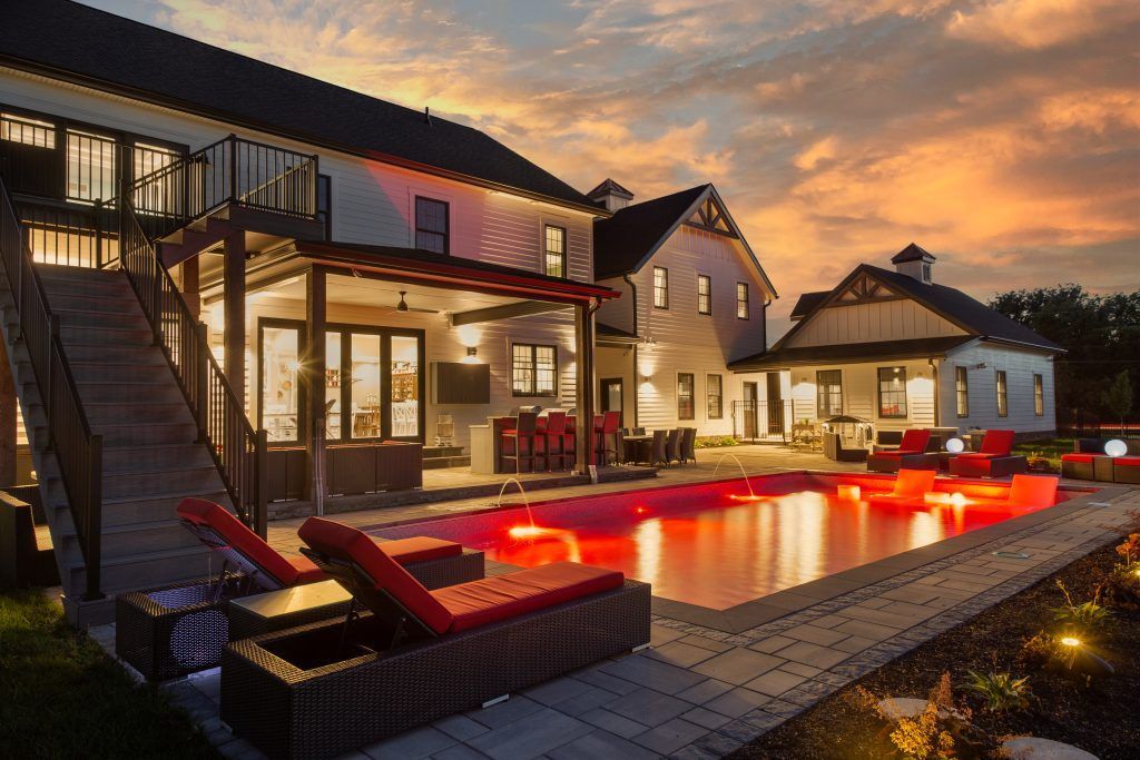 A large house with a large swimming pool in front of it