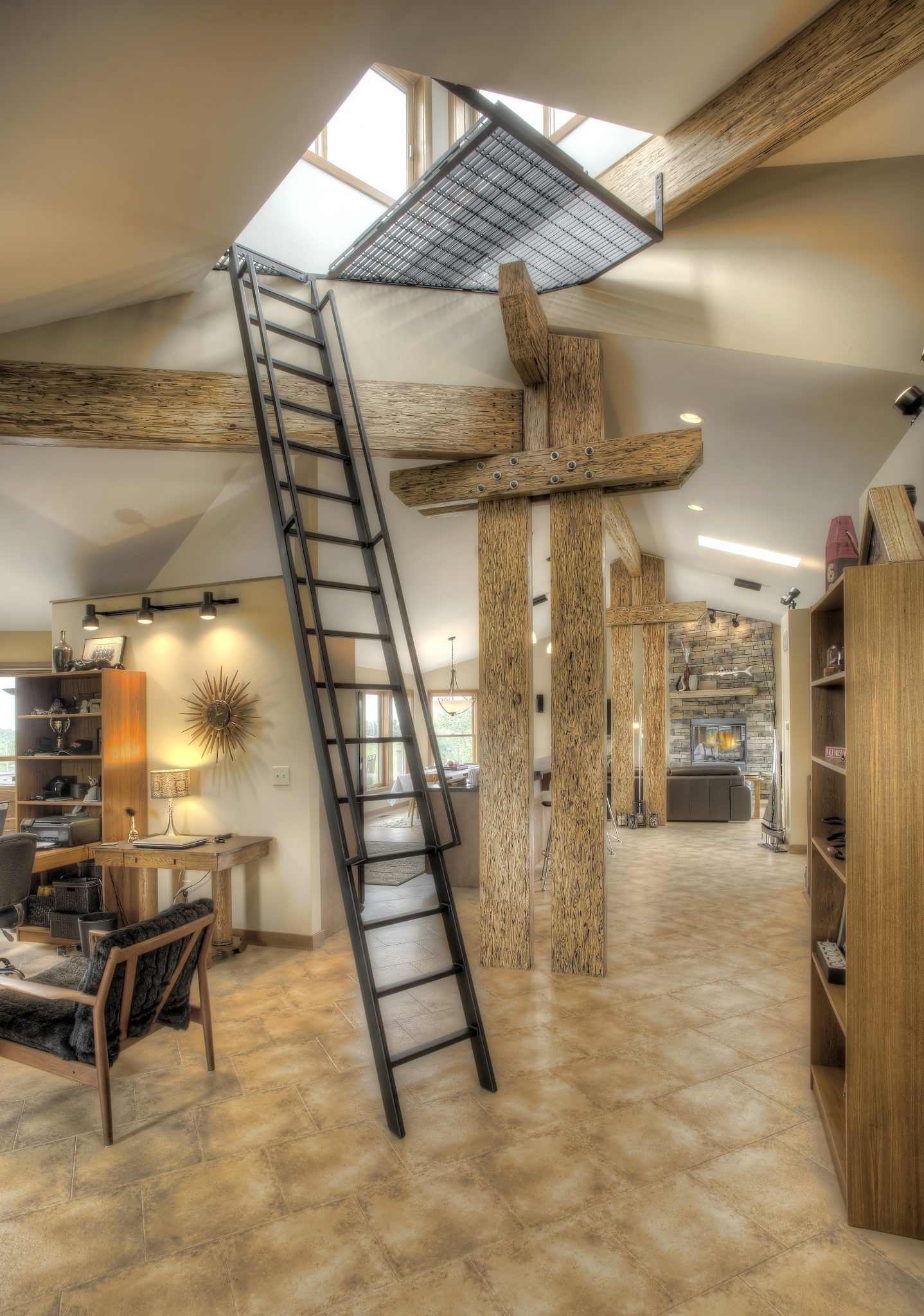 A ladder leading up to a skylight in a living room