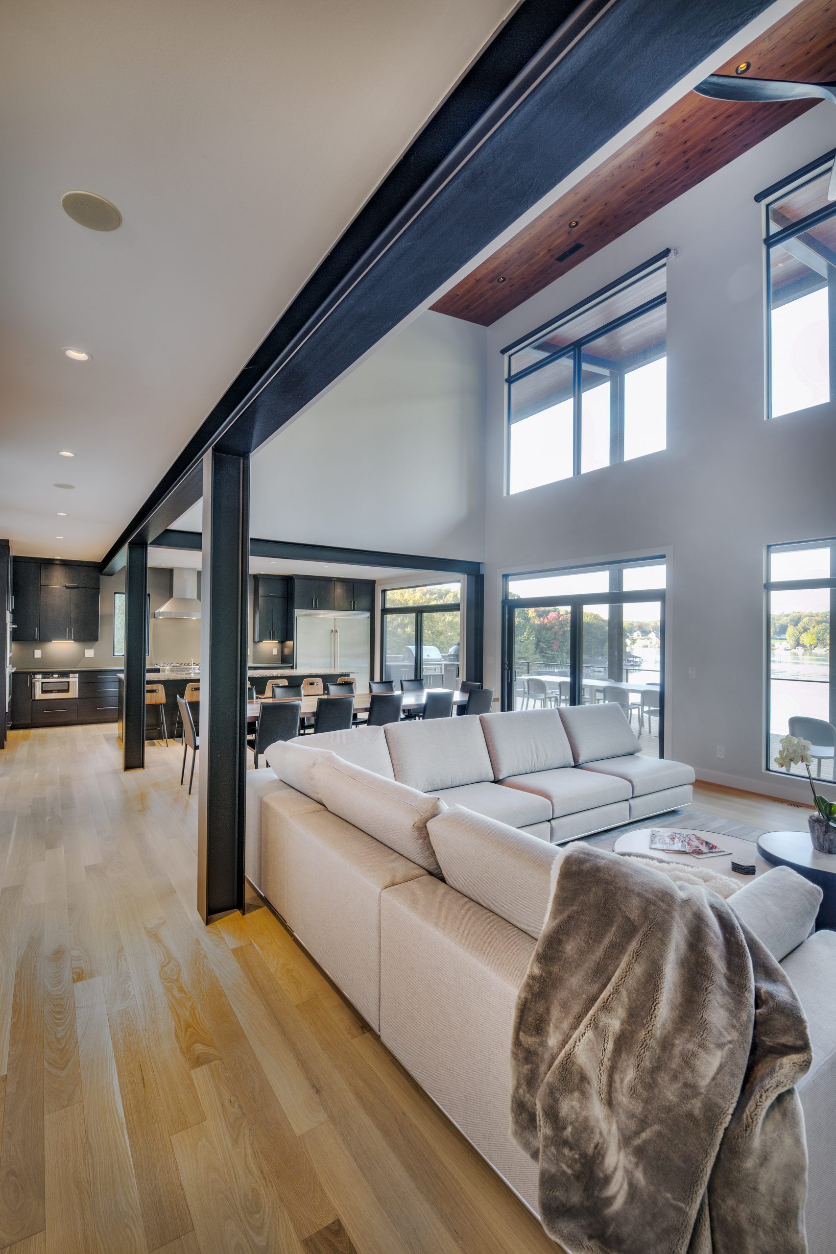A living room with a couch and a lot of windows.