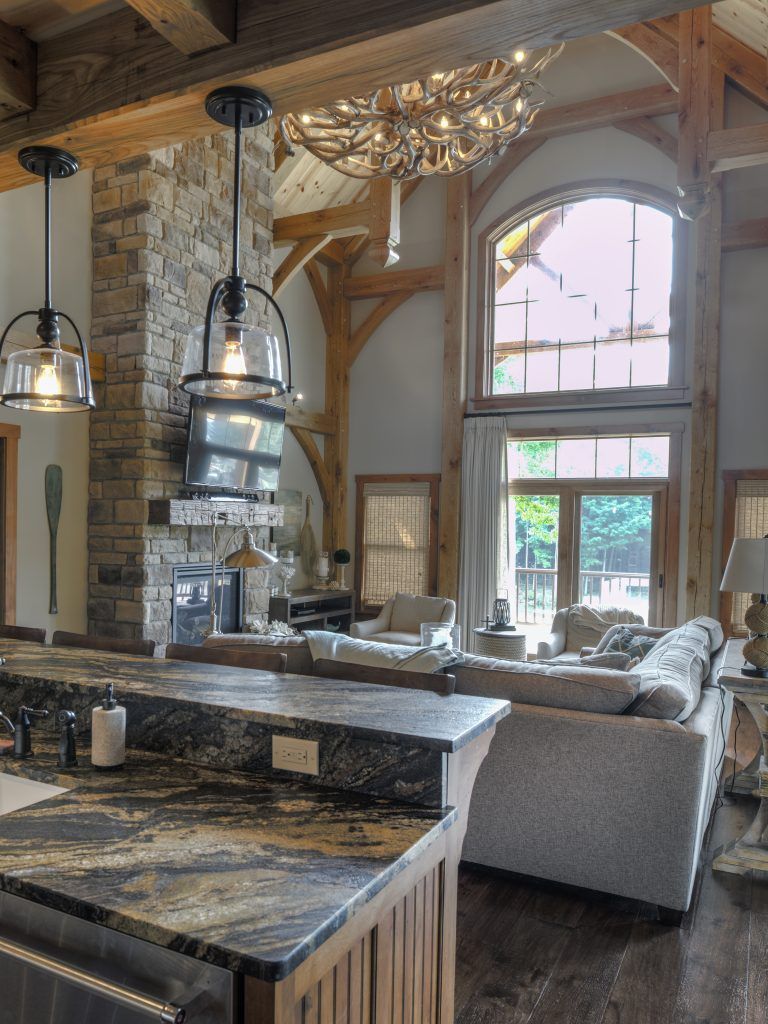 A living room with a couch, a fireplace, and a table.