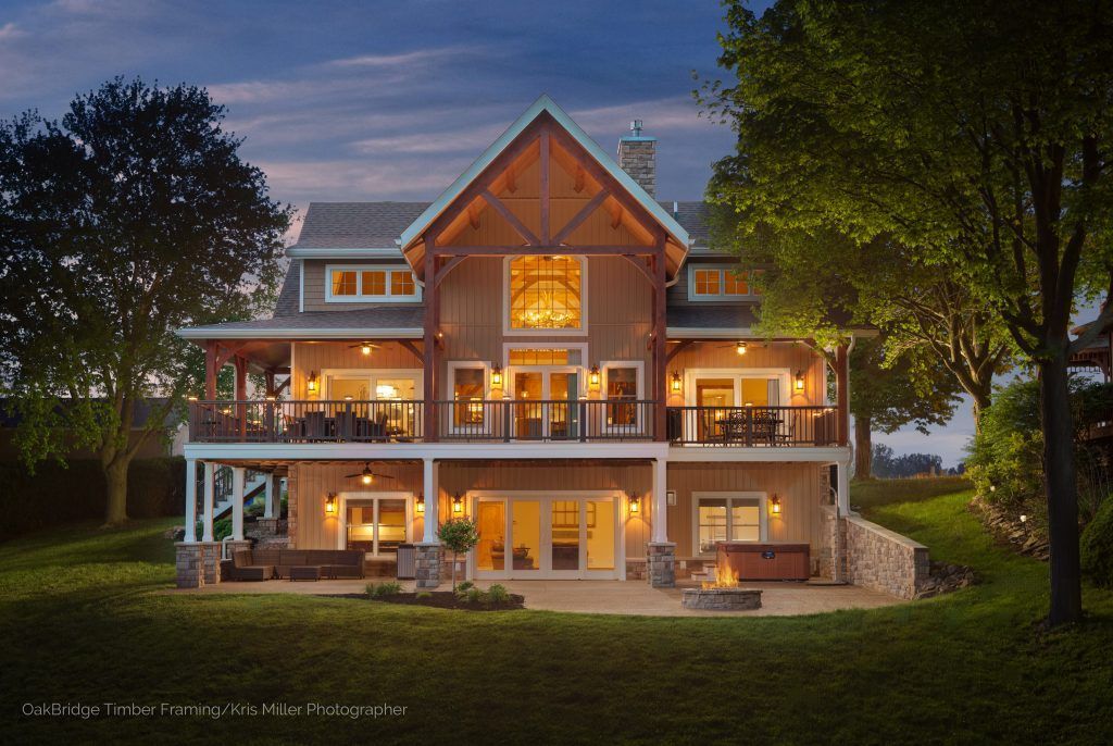 A large house with a fire pit and patio in the backyard.