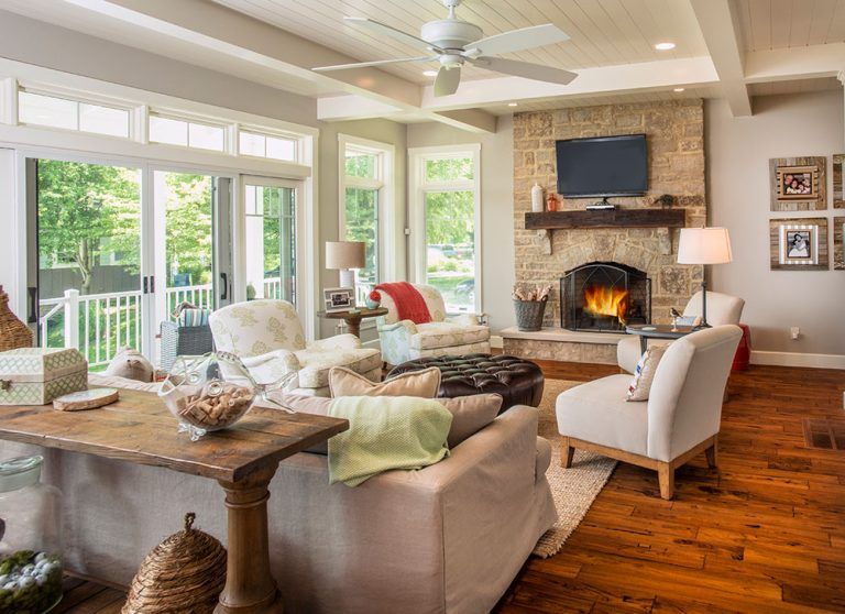 A living room with hardwood floors filled with furniture and a fireplace.