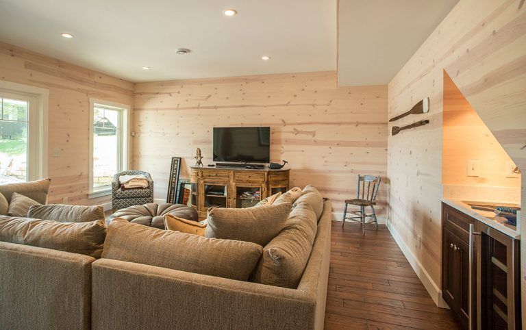 A living room with a large couch and a flat screen tv.