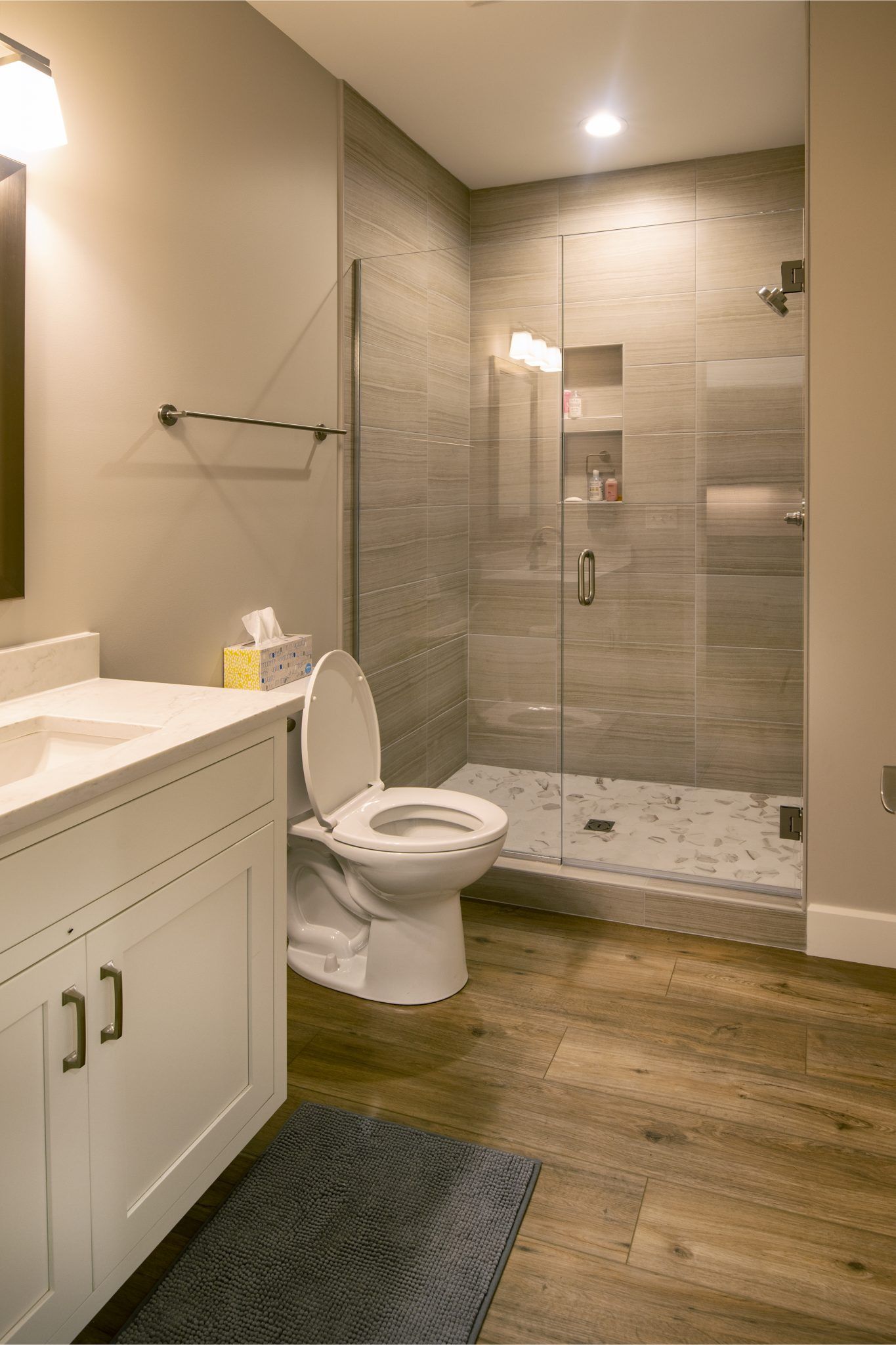 A bathroom with a toilet , sink , and walk in shower.