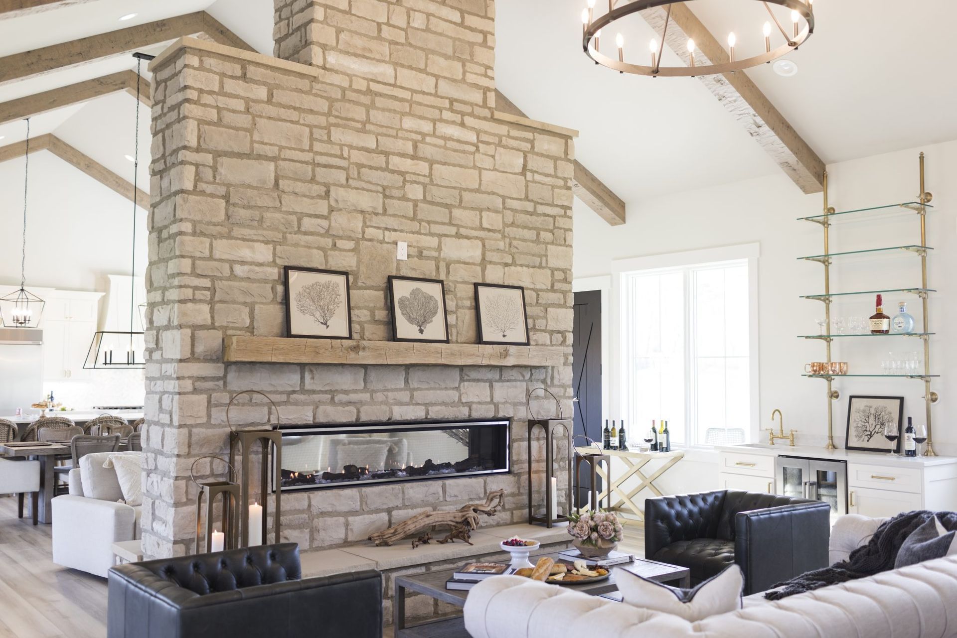 A living room with a stone fireplace and a couch.