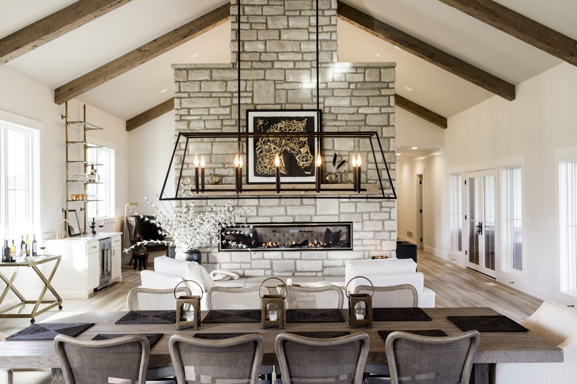 A living room with a fireplace , dining table and chairs.