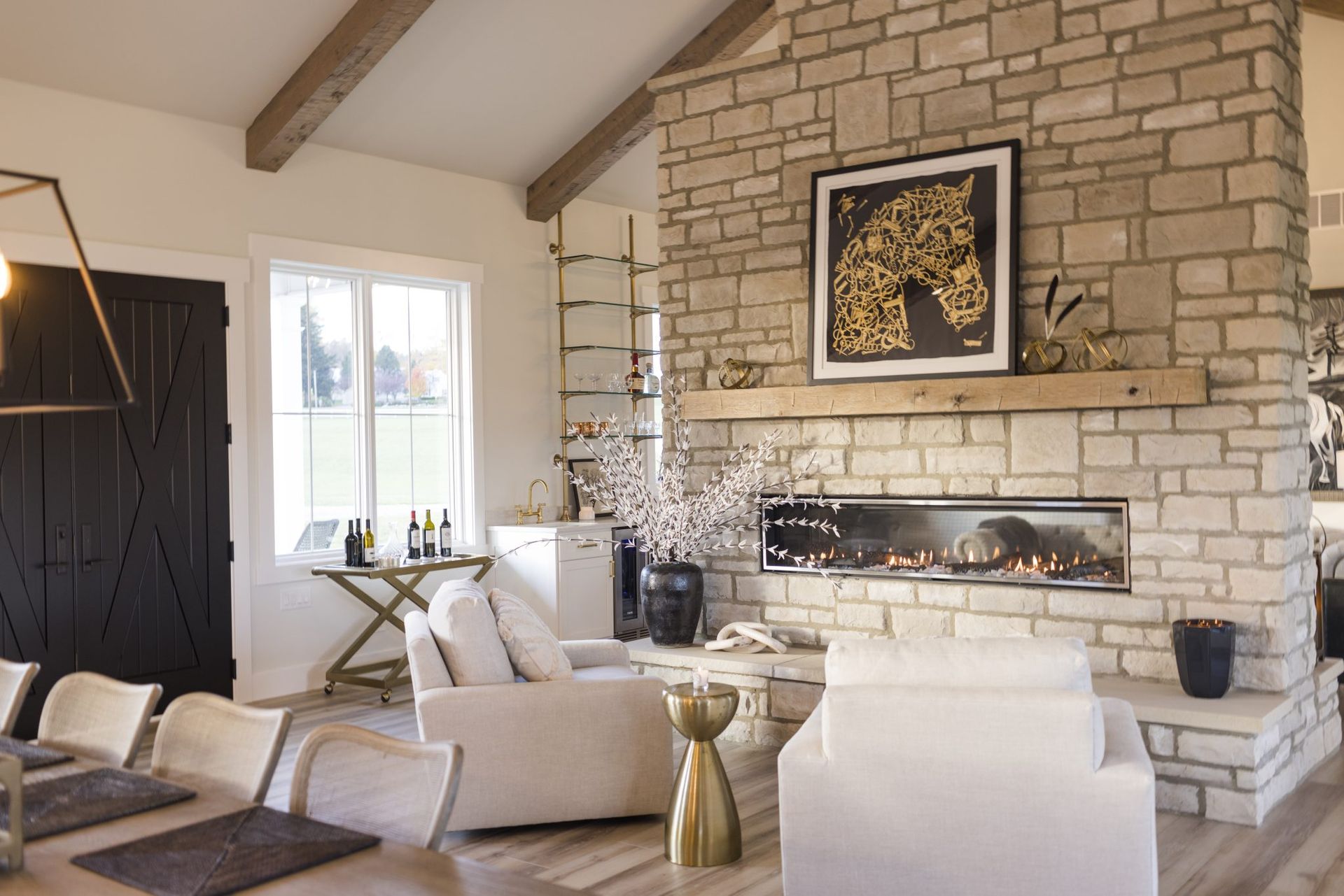 A living room with a fireplace and a dining table.