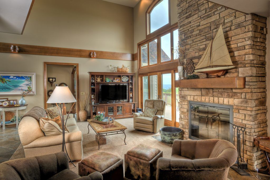 A living room with a fireplace and a sailboat on the mantle