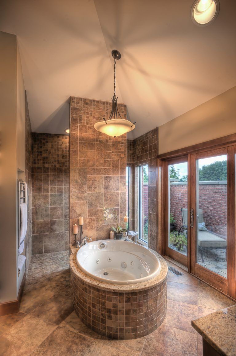A bathroom with a jacuzzi tub and a walk in shower.