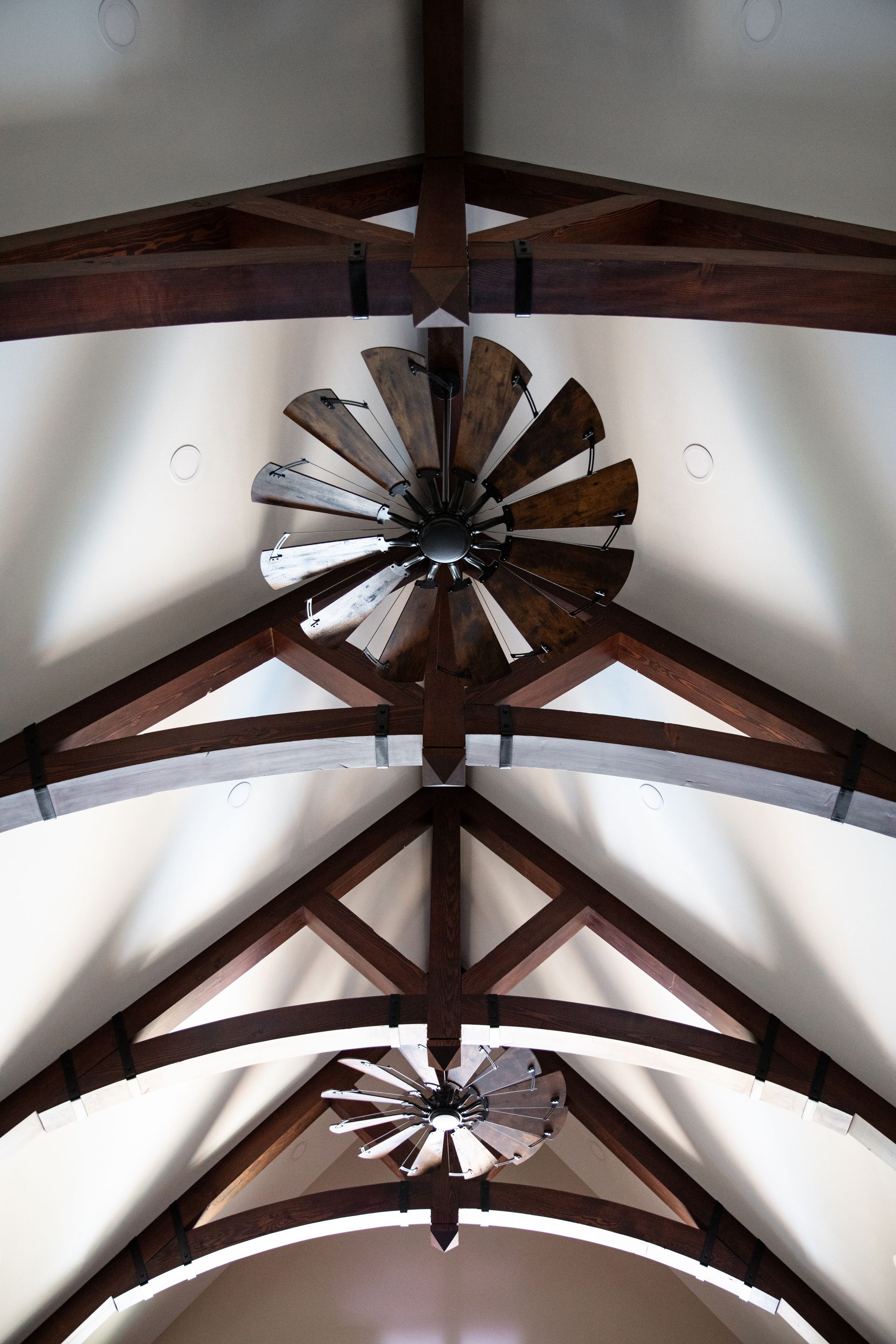 A custom ceiling fan is hanging from the ceiling of a custom home.