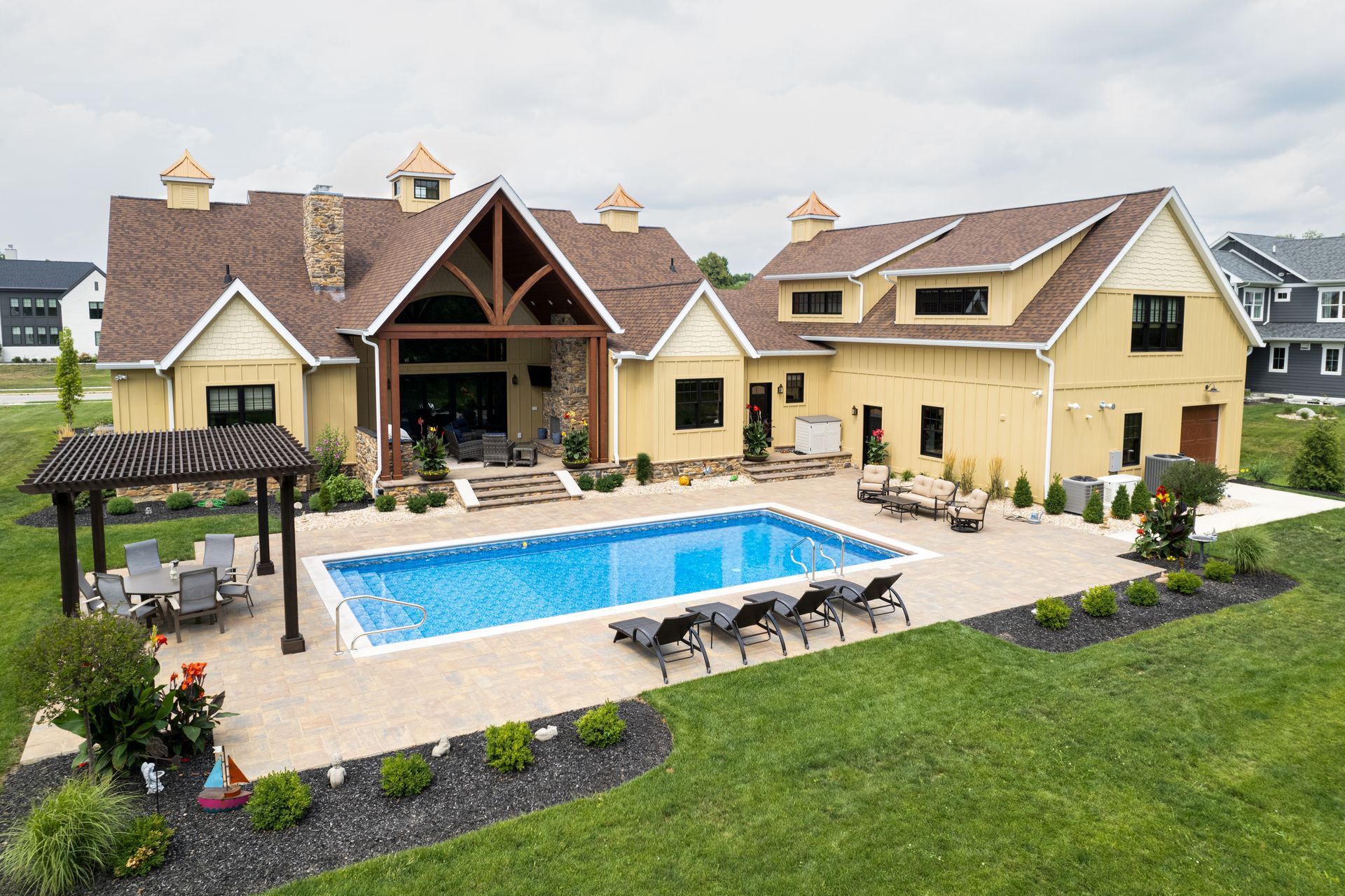 A large house with a large swimming pool in the backyard.