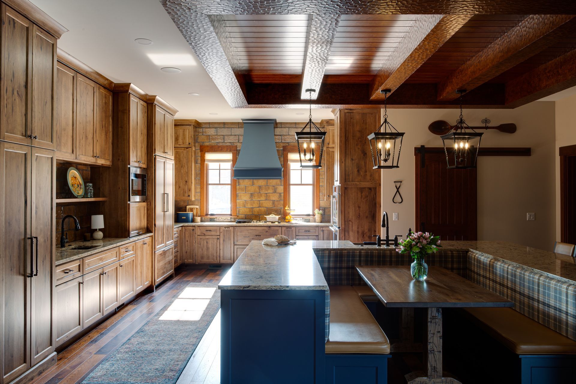 A kitchen with wooden cabinets and a blue island.