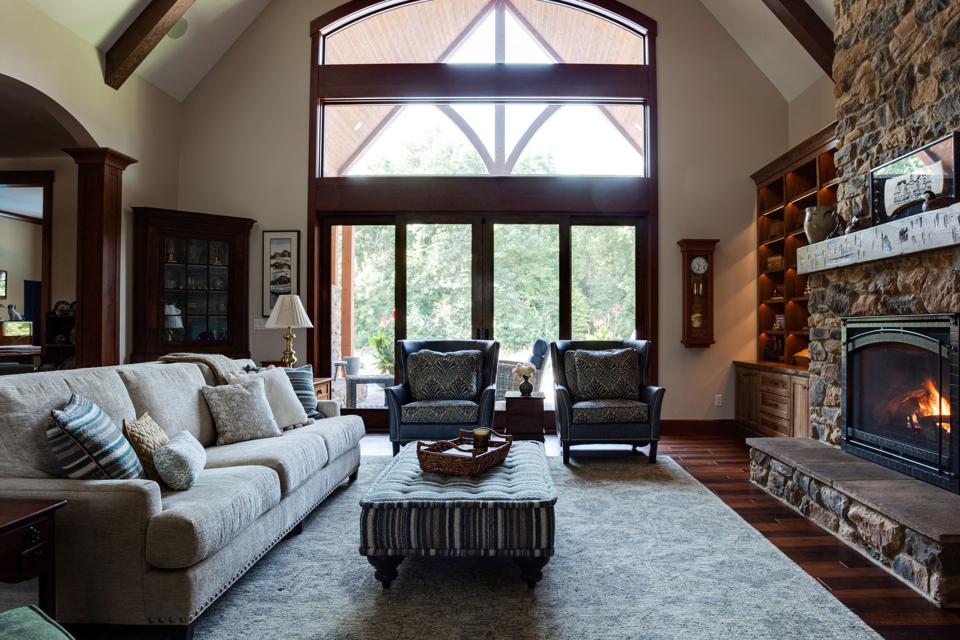A living room with a couch and chairs and a fireplace.