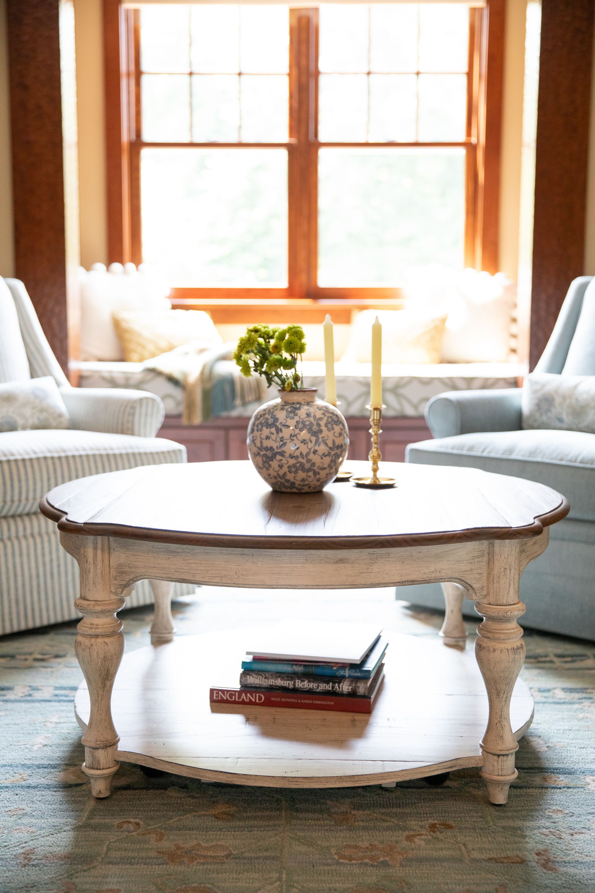 A coffee table with a vase on top of it in a living room.