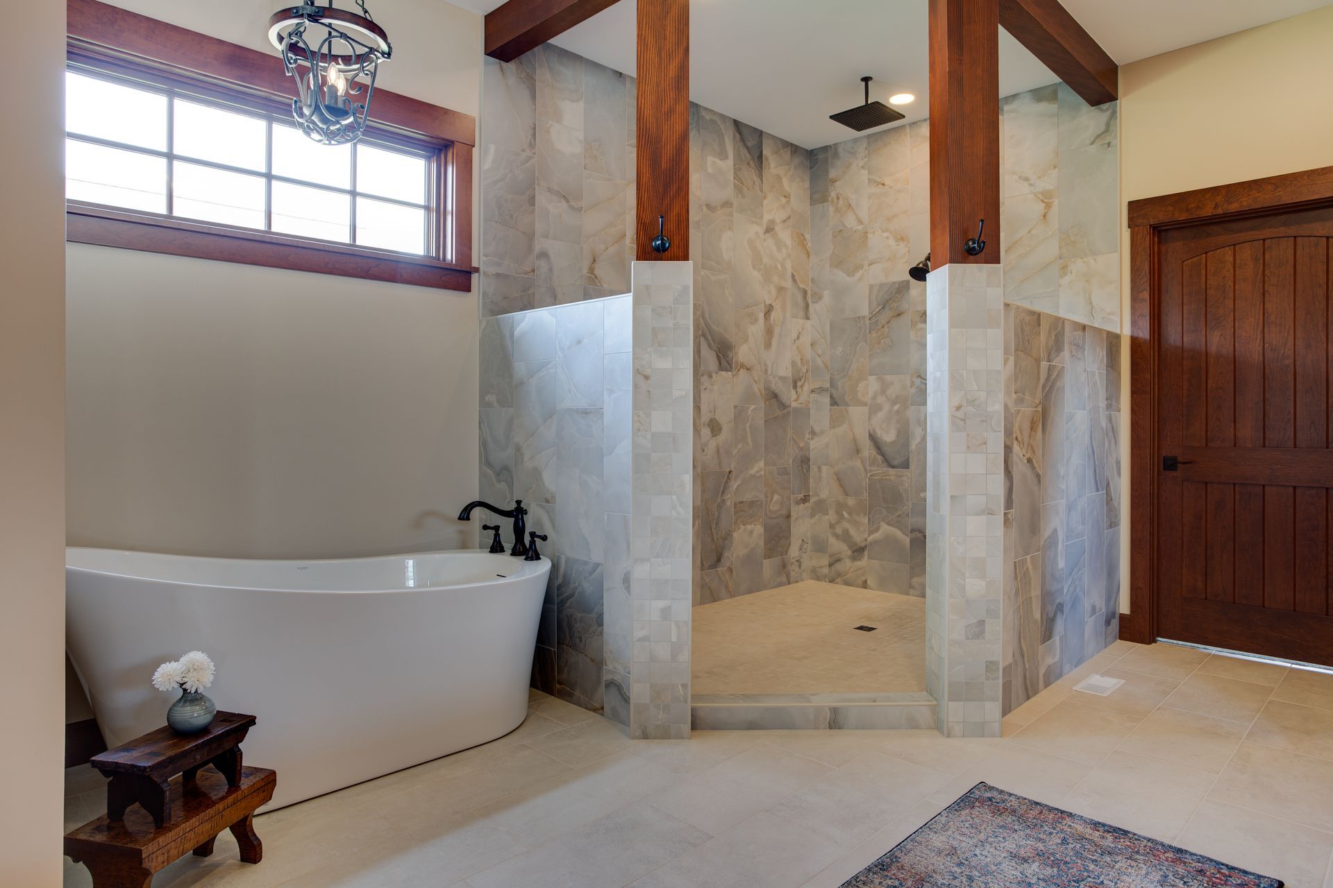 A bathroom with a tub and a walk in shower.