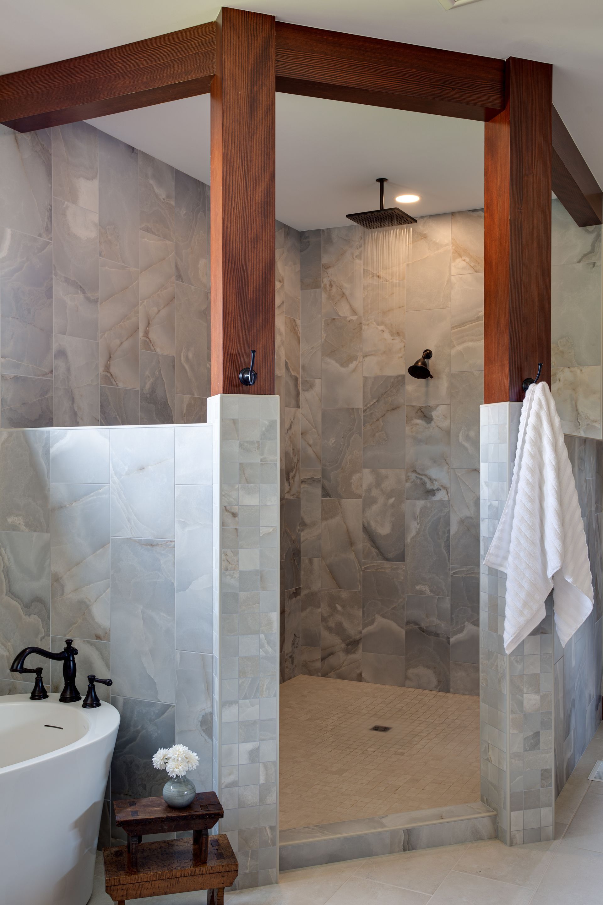 A bathroom with a walk in shower and a bathtub.