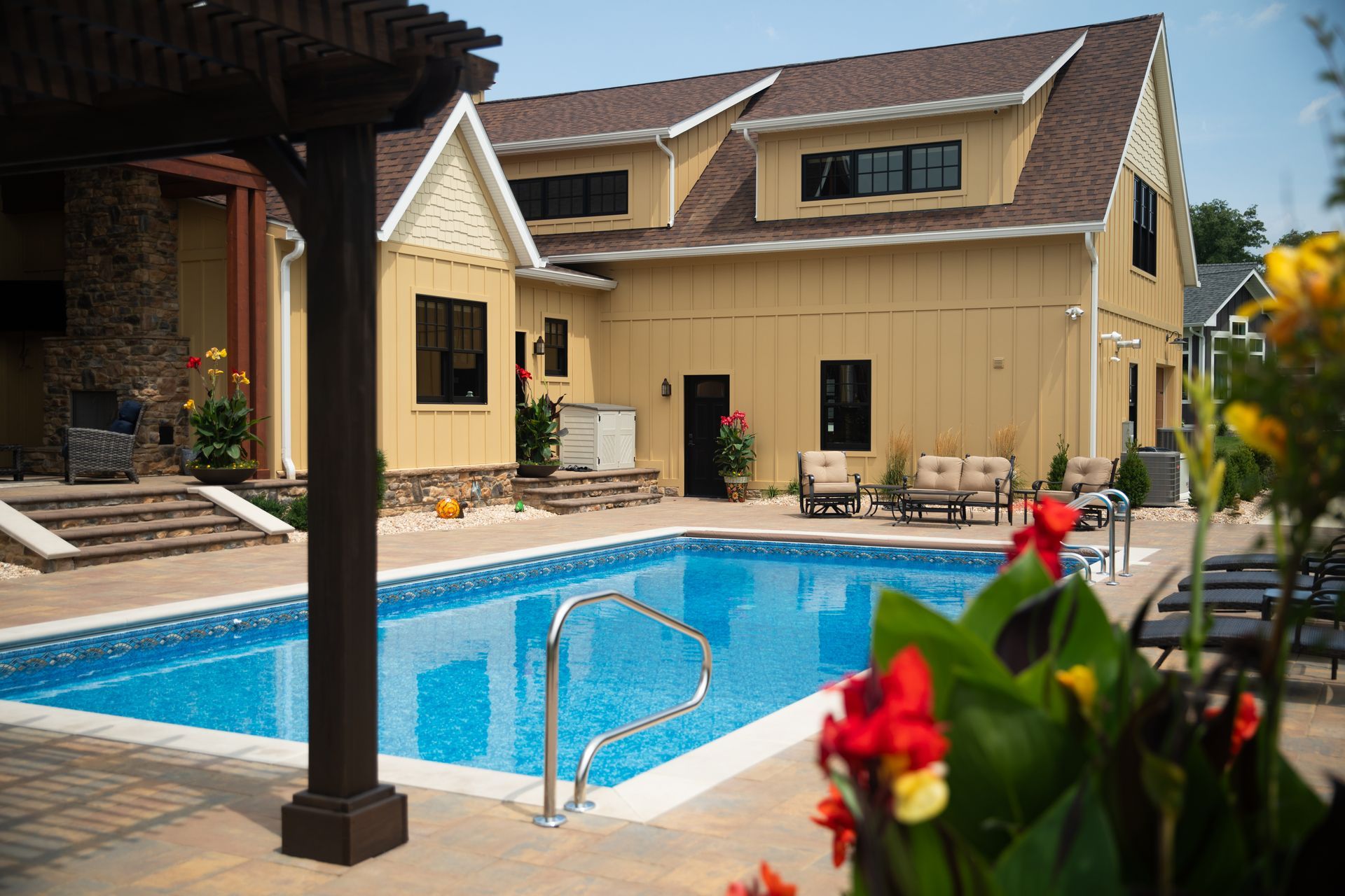 A large house with a swimming pool in front of it.