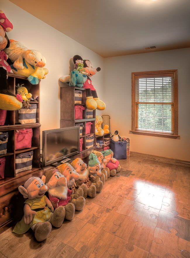 A room filled with stuffed animals and a window.
