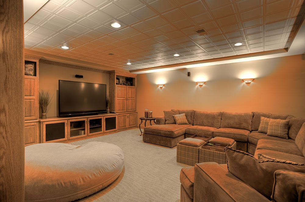 A living room with a large sectional couch and a flat screen tv.