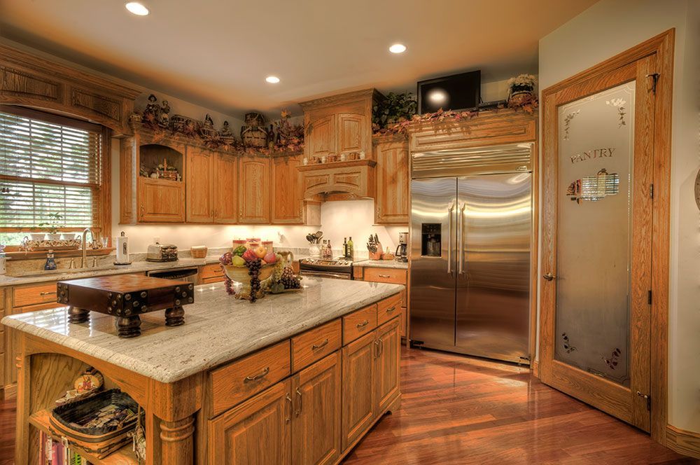 A kitchen with stainless steel appliances and wooden cabinets.