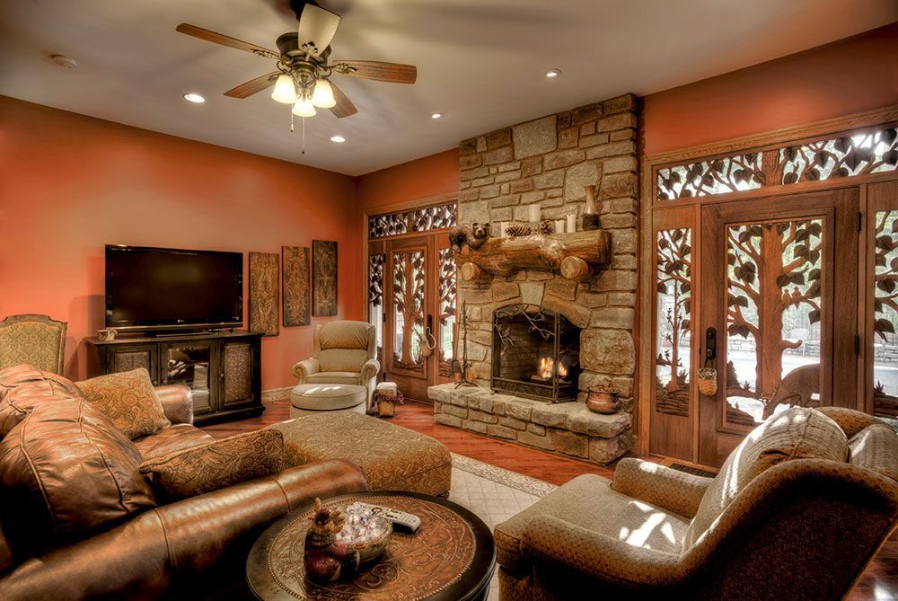 A living room with a fireplace and a flat screen tv.