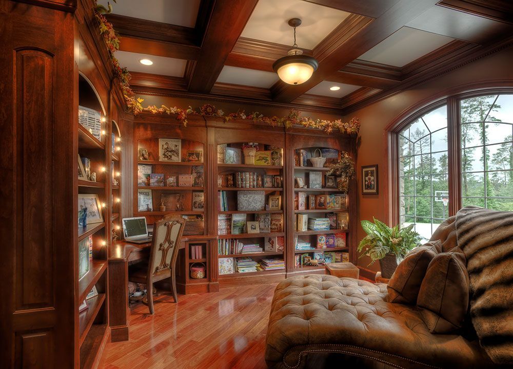 A living room filled with furniture and bookshelves.